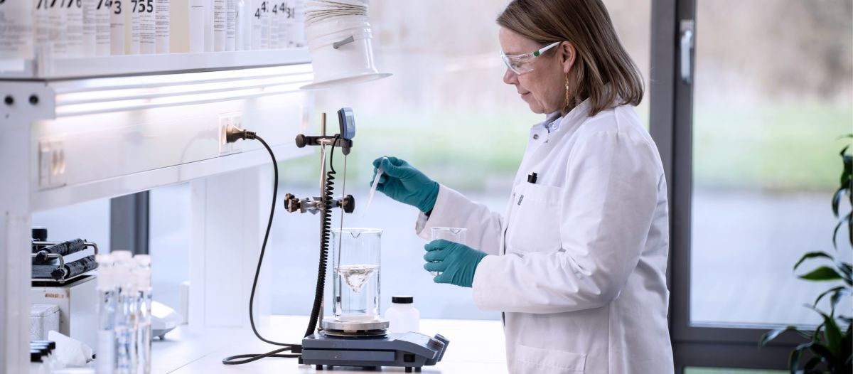 DST-CHEMICALS lab showing a person conduction industrial cleaning tests